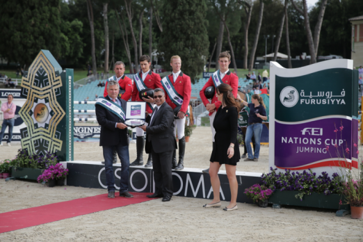 Photo Caption: The Belgian team enjoyed their very first victory in Rome (ITA) today when winning the third leg of the Furusiyya FEI Nations Cup™ Jumping Europe Division 1 league. Pictured on the podium are: (L to R) Ludo Philippaerts, Nicola Philippaerts, Niels Bruynseels and Constant van Paesschen. Front (L to R) Belgian Chef d’Equipe Kurt Gravemeier, Dr Adil Nofal, Kingdom of Saudi Arabia’s Deputy Ambassador to Italy and Mrs Eleonora di Giuseppe, Coordinator CSIO Rome. Photo: Stefano Secci/FEI.