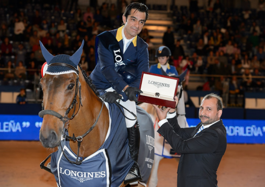 Photo Caption: Colombia’s Carlos Lopez, winner of the sixth leg of the Longines FEI World Cup™ Jumping 2014/2015 Western European League in Madrid, Spain today, pictured with his winning horse, Prince de la Mare, and Longines Brand Manager for Spain, Miguel Angel Palmer. (FEI/Herve Bonnaud).