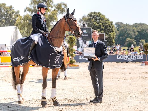 Foto: Übergabe des Ehrenpreises durch Thomas Bergmann, Longines Repräsentant Deutschland, und Siegesjubel von Laura Collett - Fotograf: TGL / Annette Dölger