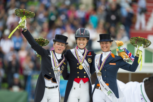 On the podium for the Grand Prix Freestyle at the Alltech FEI World Equestrian Games™ 2014 in Normandy, L to R: Germany’s Helen Langehanenberg (silver), Great Britain’s Charlotte Dujardin (gold) and The Netherlands’ Adelinde Cornelissen (bronze). (Dirk Caremans/FEI) 