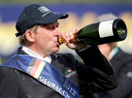 Foto: Der Brite Nick Skelton nimmt einen Schluck auf den Sieg. - Fotograf: Daniel Reinhardt - dpa