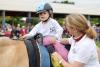 Foto: Zeigt einen Programmpunkt des Therapeutischen Reitens beim Soerser Sonntag - Fotograf: CHIO Aachen/ Andreas Steindl